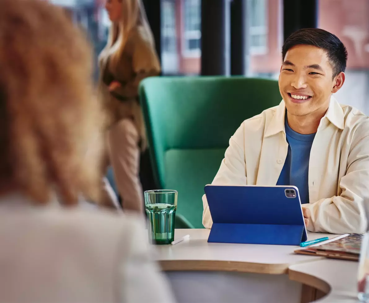 smiling man at work using tablet