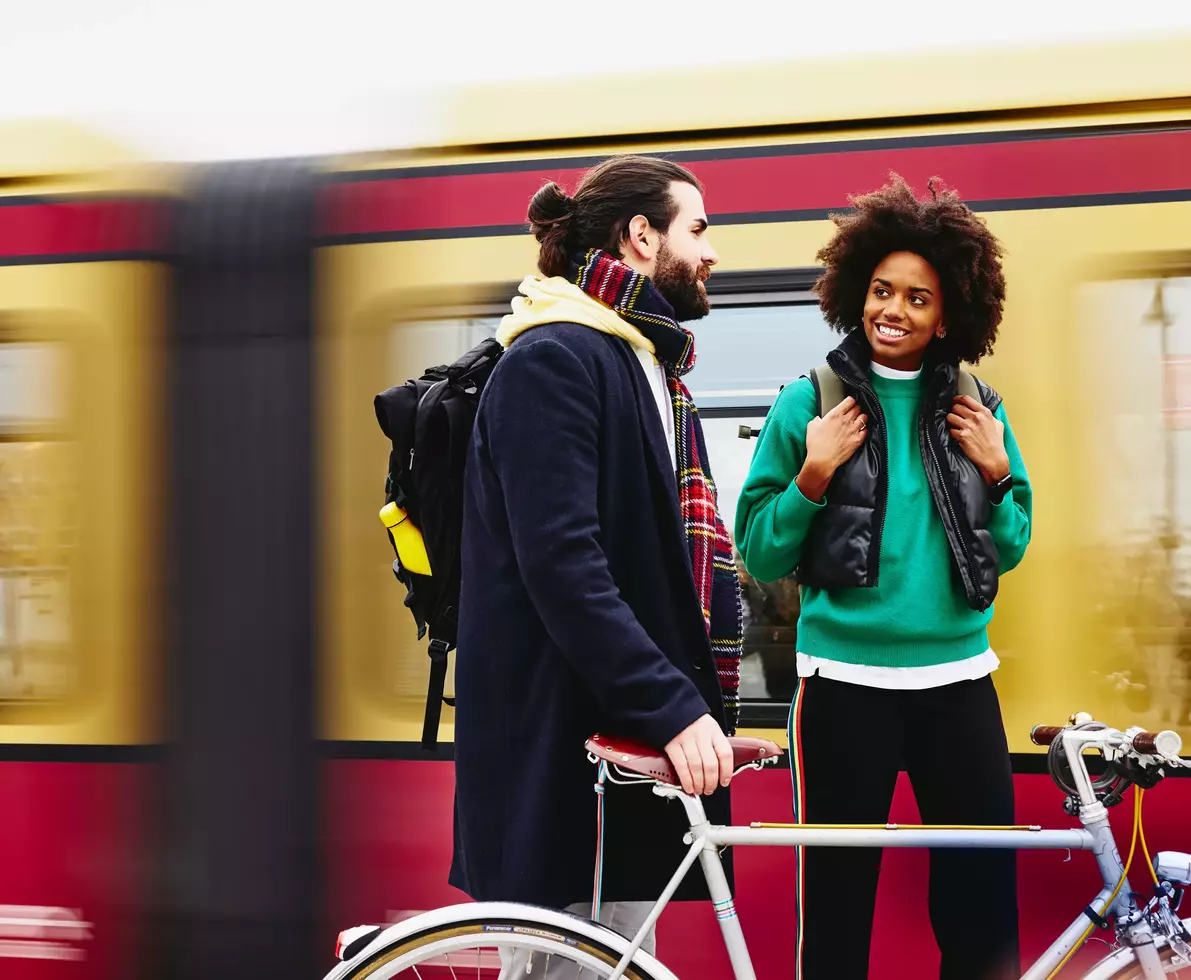 woman and man having a conversation at the train station