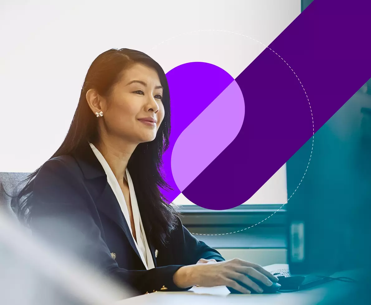 smiling woman at work on a desktop compter