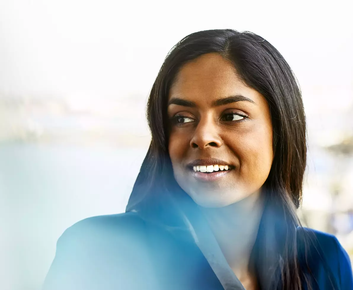 smiling woman, construction site in the background