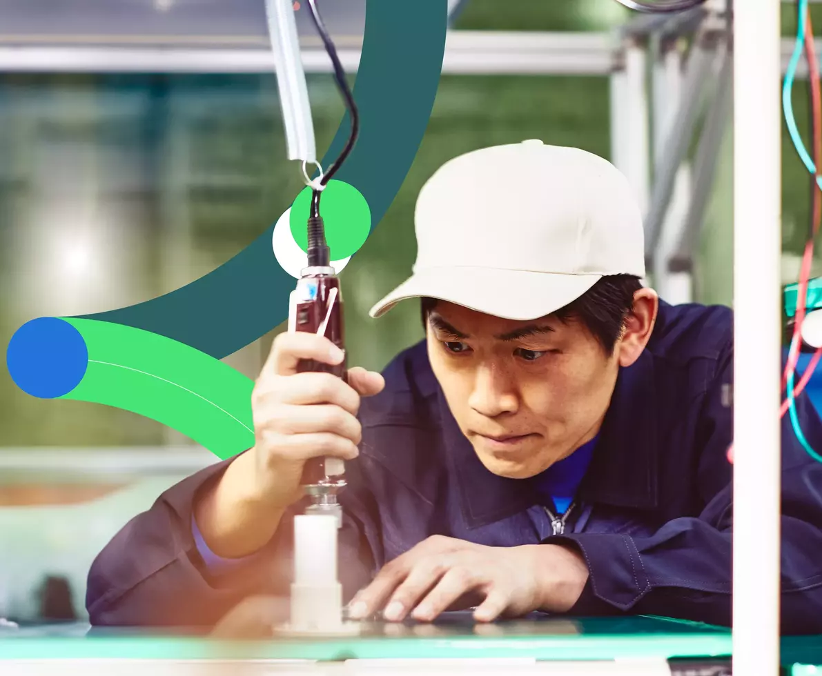 male worker wearing white cap in a production setting