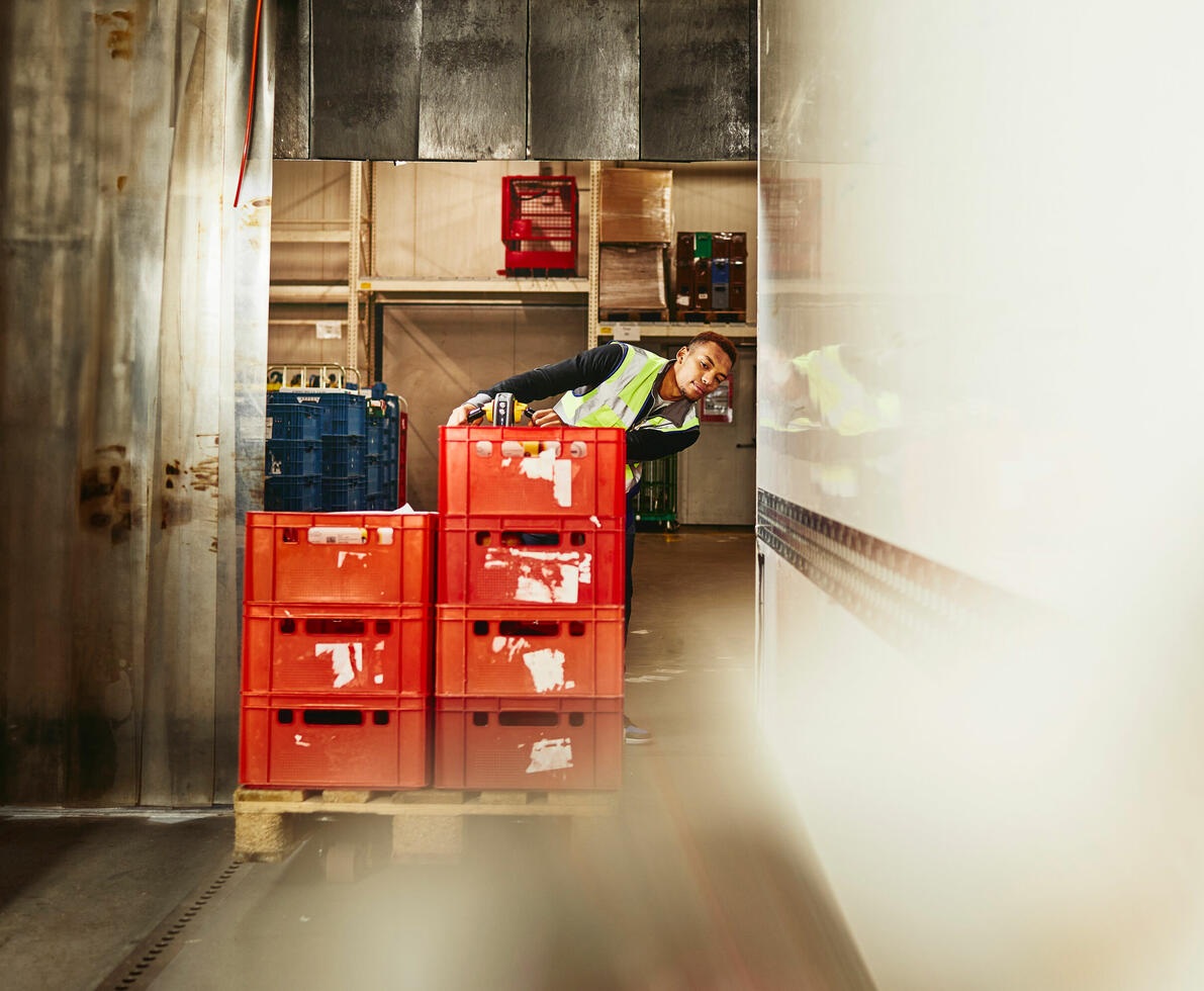 A man moving crates