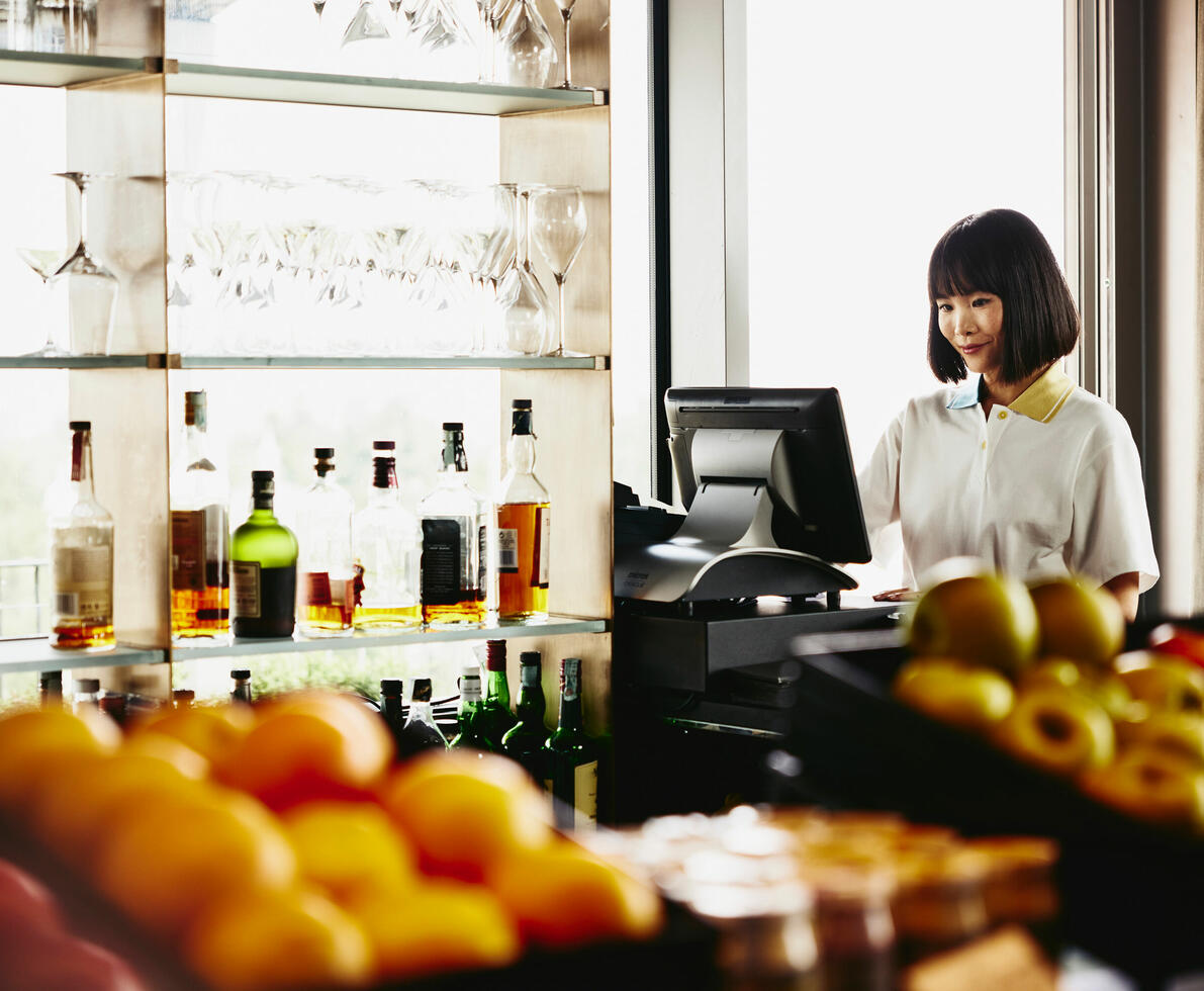 A woman working on a computer in a store