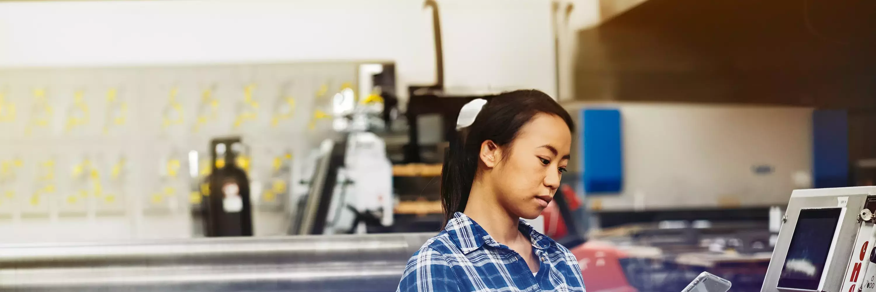 woman inputting into a tablet to operate machinery woman inputting into a tablet to operate machinery