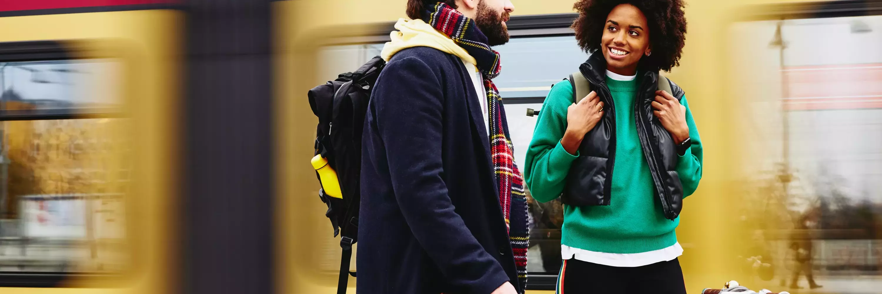 woman and man having a conversation at the train station
