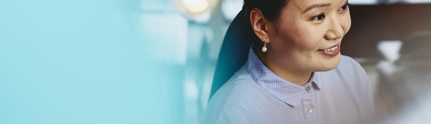 Woman with earrings smiling. Japan. Primary color: blue.