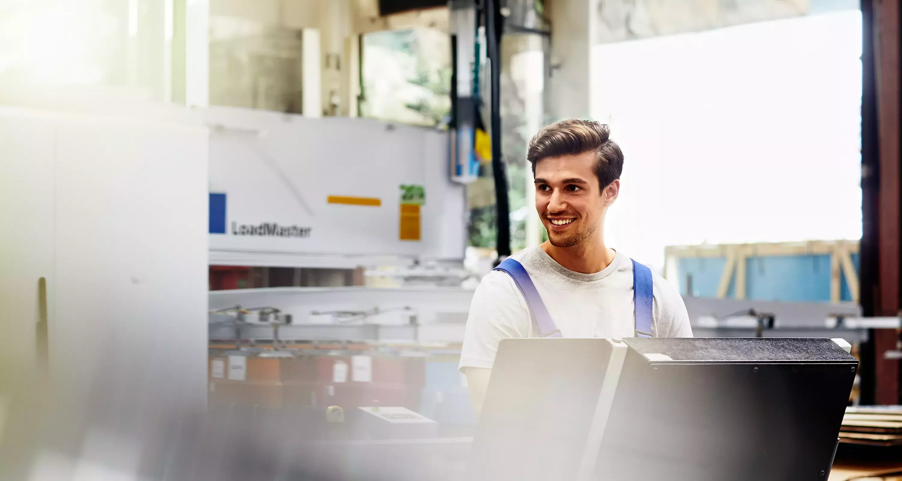 Smiling male on a production site