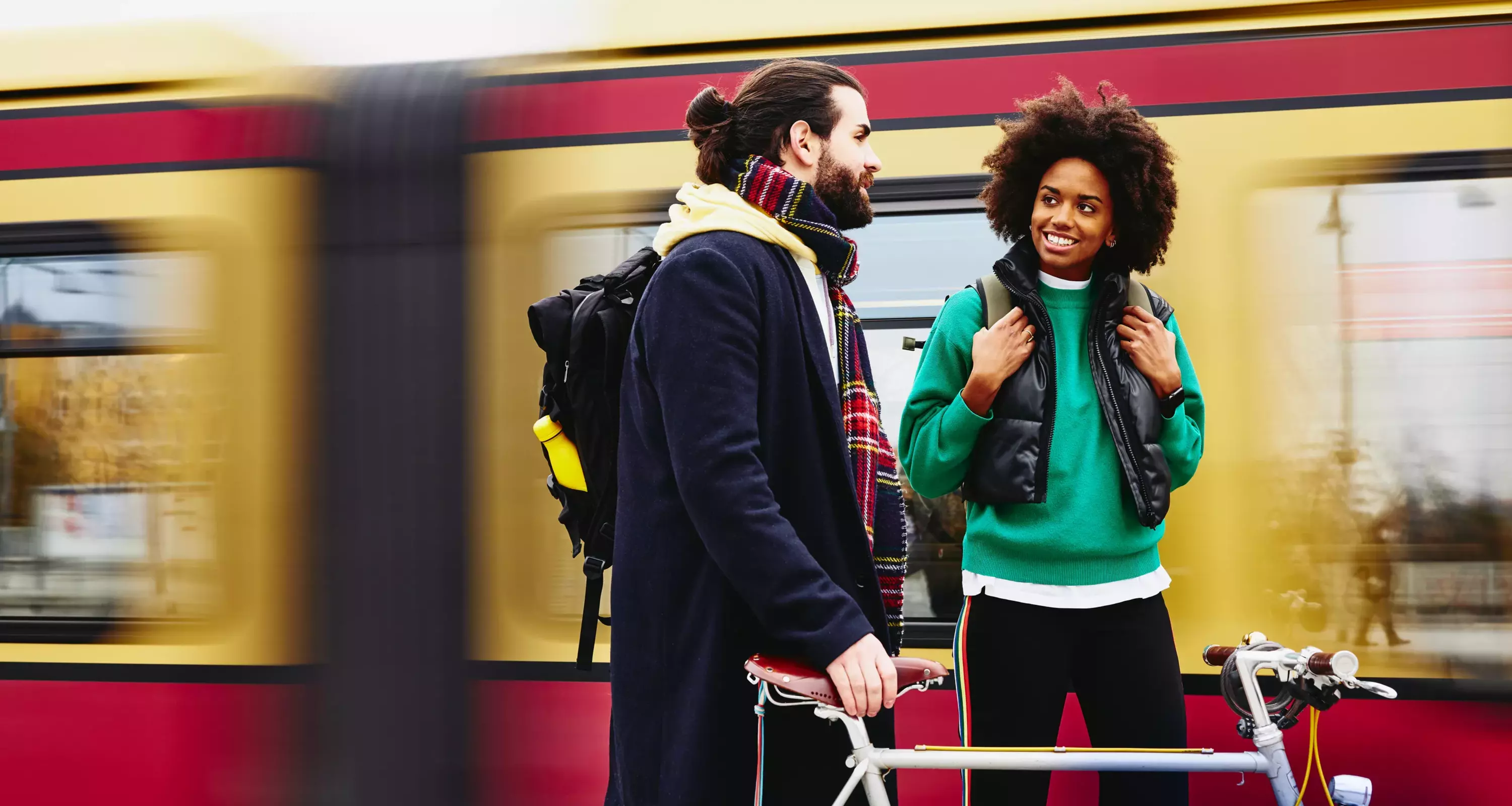 woman and man having a conversation at the train station